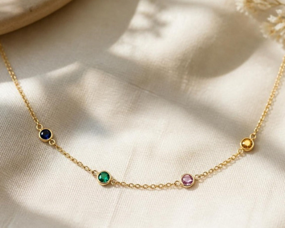 Birthstone family necklace in 14k gold with four bezel-set stones