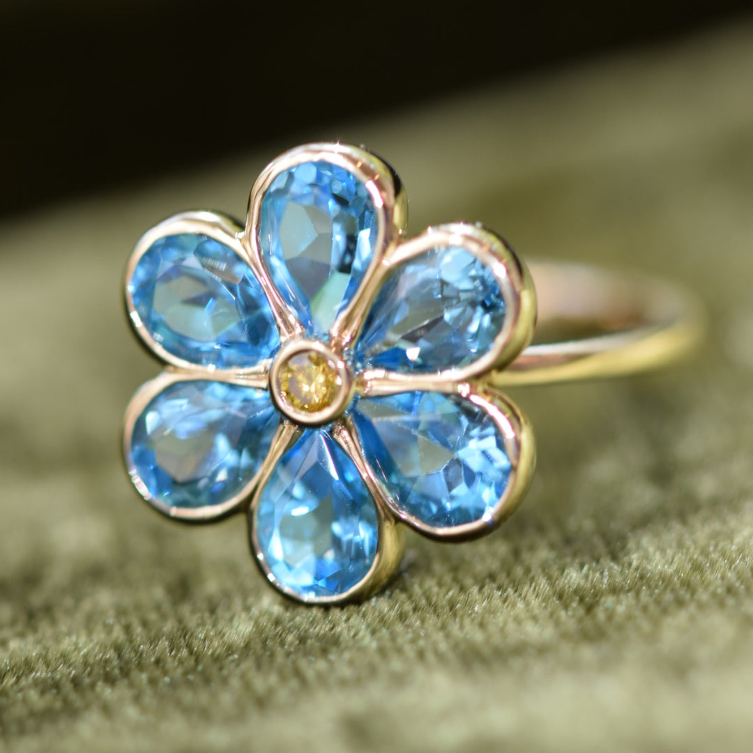 14K solid gold custom flower ring with blue topaz gemstone petals by Kate Rose Fine Jewelry