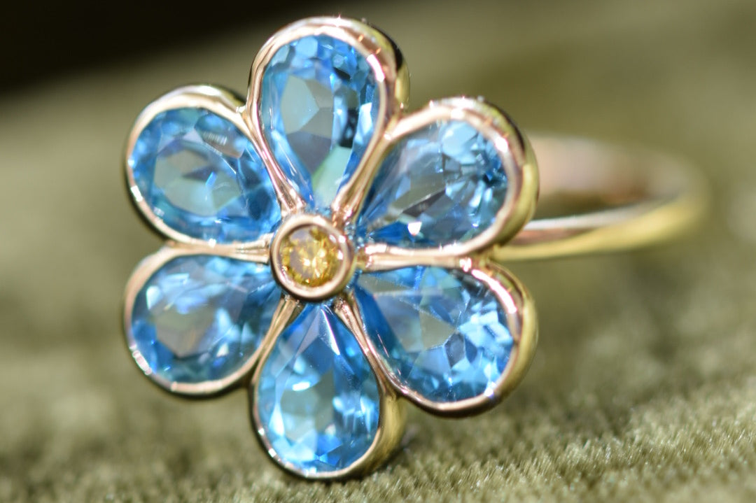 14K solid gold custom flower ring with blue topaz gemstone petals by Kate Rose Fine Jewelry