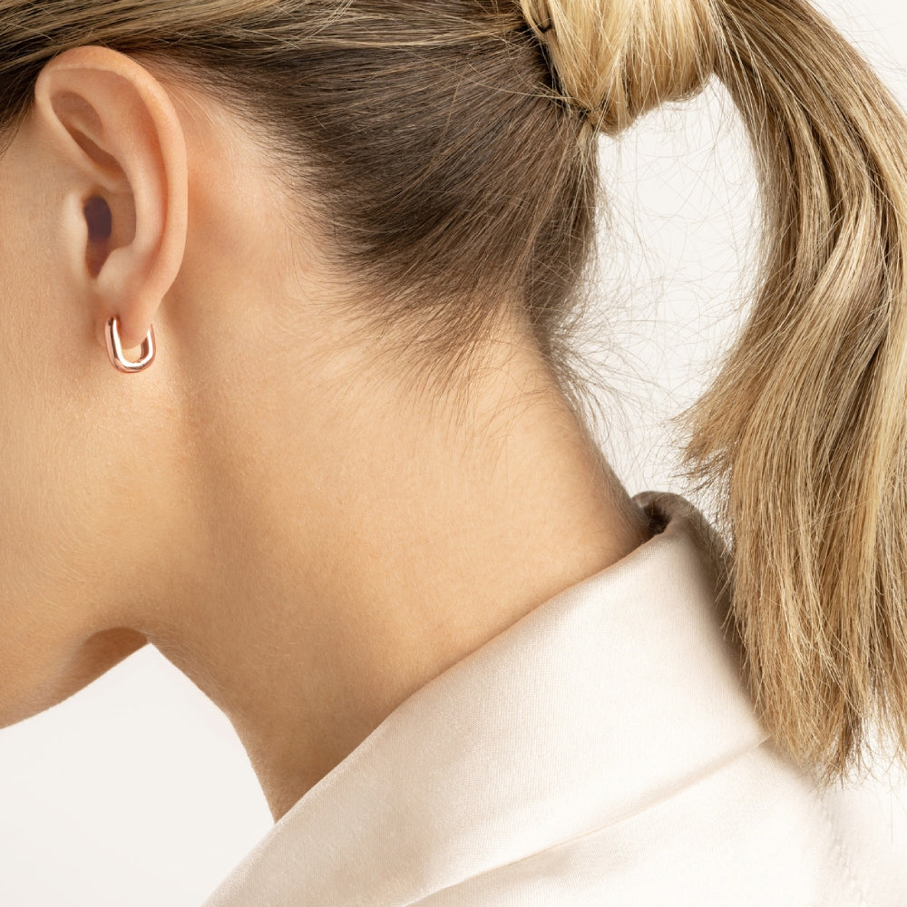 Oblong Polished Hoop Earrings in Rose Gold on a Model